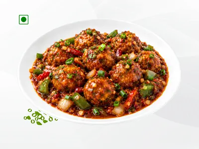 A flavorful 150g portion of crispy veg Manchurian balls tossed in a tangy, thick soy-garlic gravy by Wheeler's Food.